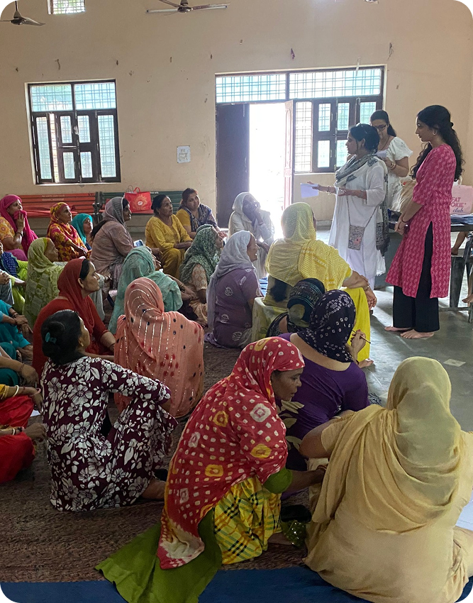 Community session with women seated on the floor discussing health