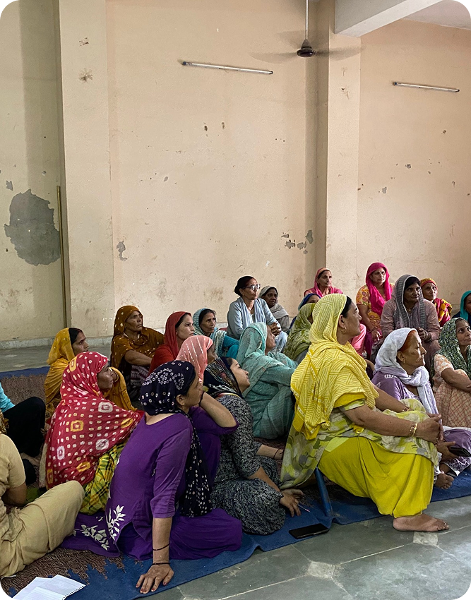 Community awareness session with women listening attentively