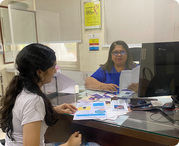 Dr. Meenakshi Ahuja reviewing educational pamphlets at Fortis La Femme
